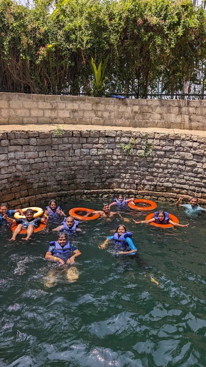 Creo teammates cooling off together in a stepwell pool