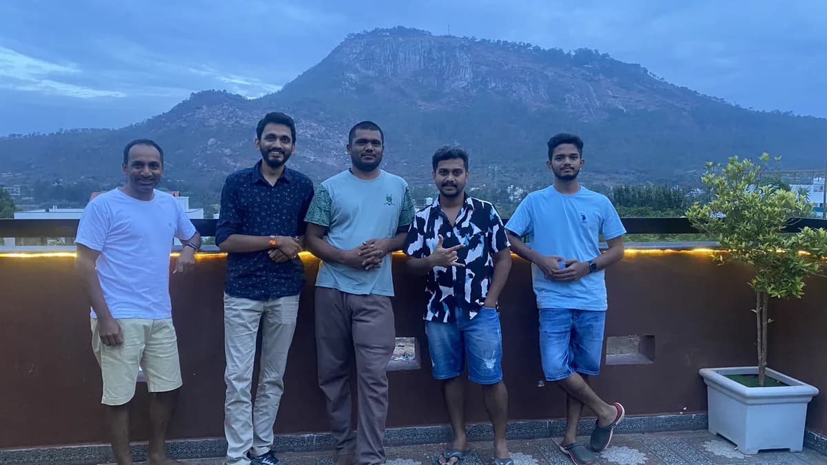 Creo teammates together on a hillside during an offsite